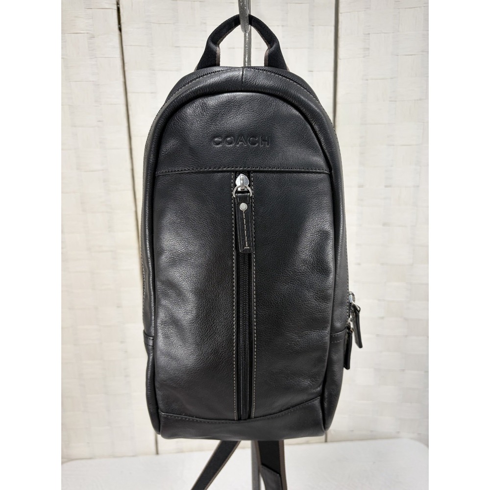 Coach Heritage black leather sling bag vertical front zip pocket embossed logo